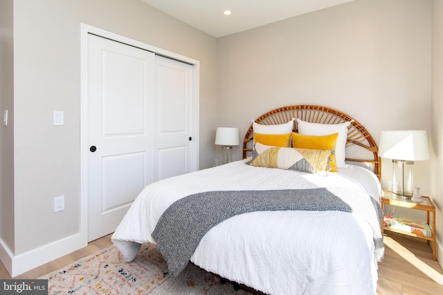 bedroom featuring light wood-type flooring and a closet