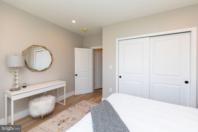 bedroom featuring a closet and light wood-type flooring