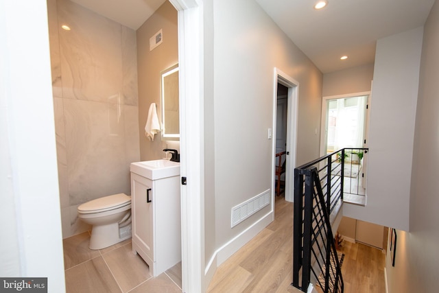 bathroom featuring vanity, toilet, and wood-type flooring