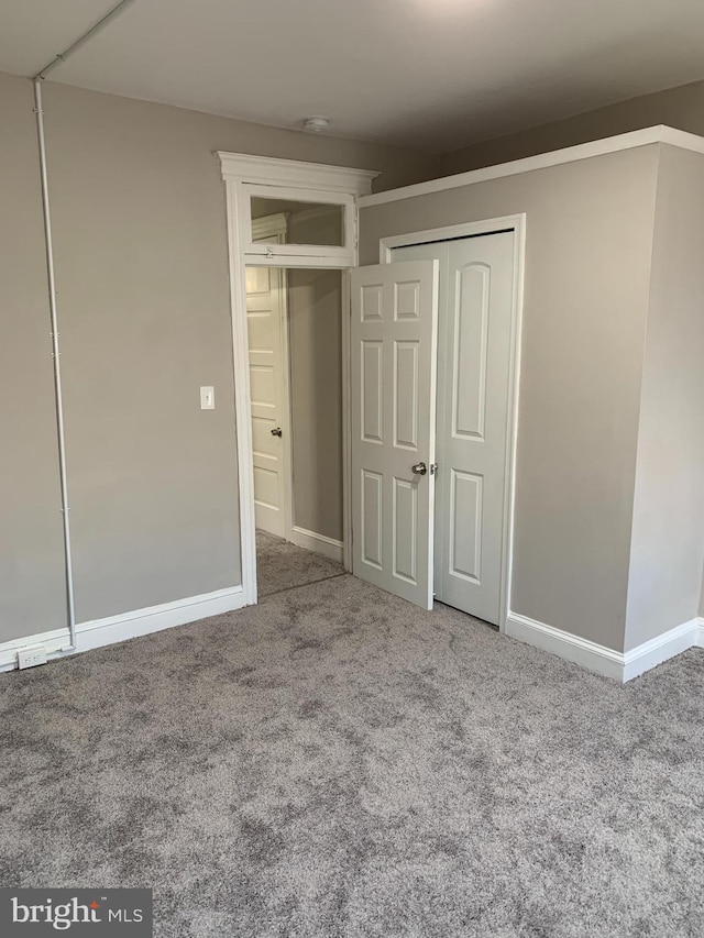 unfurnished bedroom with carpet floors and a closet