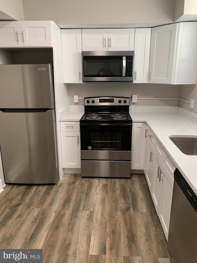 kitchen with white cabinetry, dark hardwood / wood-style flooring, and stainless steel appliances