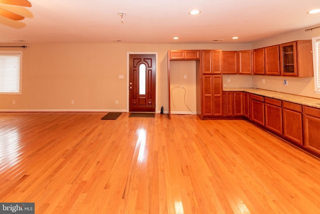 kitchen with ceiling fan and light hardwood / wood-style flooring