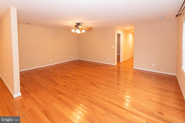 empty room with light hardwood / wood-style flooring and ceiling fan