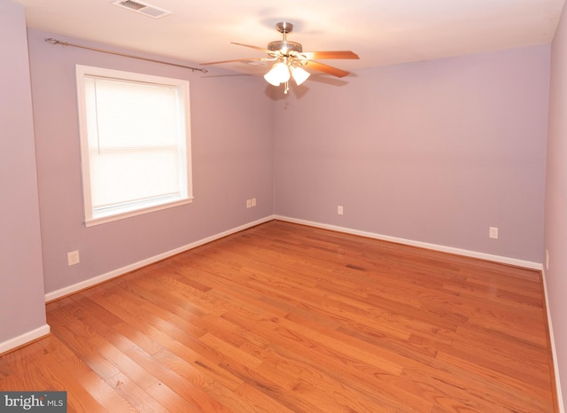 spare room with ceiling fan and light wood-type flooring