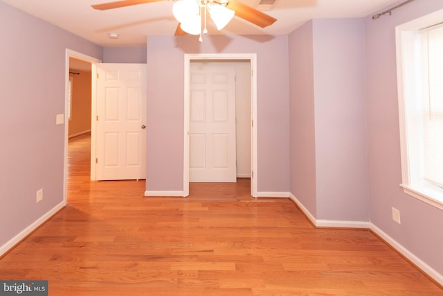 unfurnished bedroom with multiple windows, light hardwood / wood-style floors, and ceiling fan