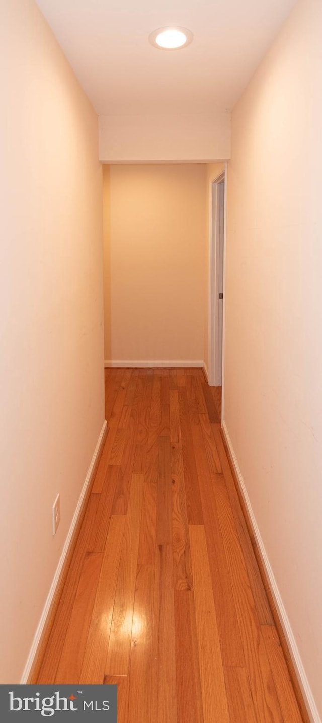 corridor with light hardwood / wood-style floors