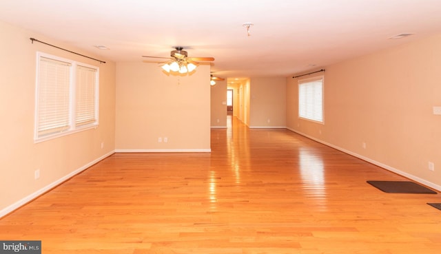 empty room with light hardwood / wood-style floors and ceiling fan