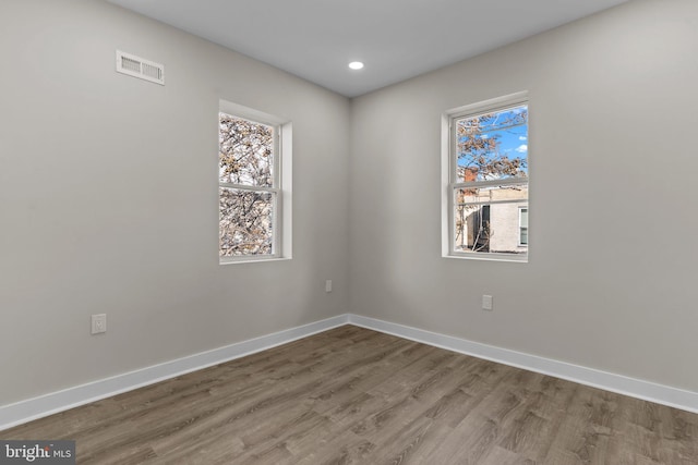 unfurnished room featuring hardwood / wood-style floors