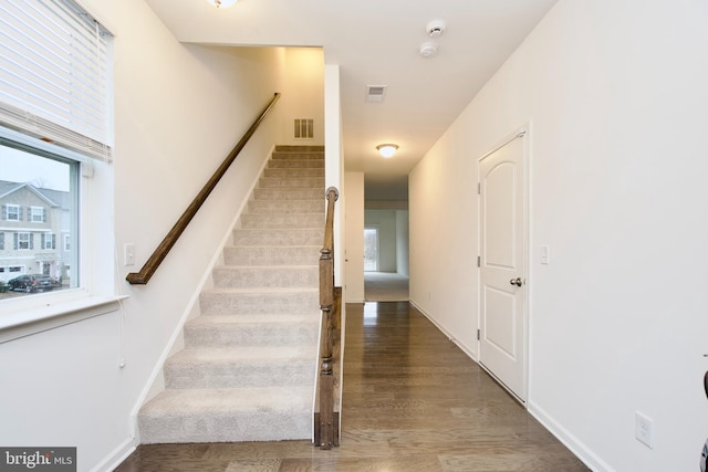 stairs with wood-type flooring