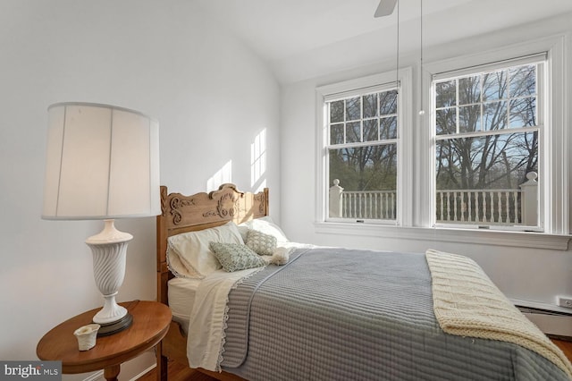 bedroom featuring multiple windows and vaulted ceiling