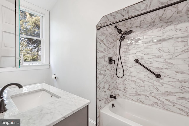 bathroom featuring  shower combination and vanity