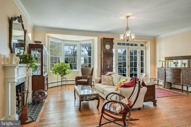 living area with crown molding, a fireplace, light wood finished floors, and baseboard heating