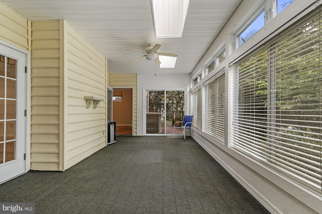 unfurnished sunroom with ceiling fan