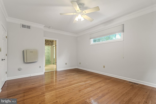 spare room with ornamental molding, hardwood / wood-style floors, and ceiling fan