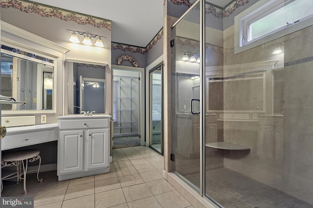 bathroom with vanity, a shower with shower door, and tile patterned flooring