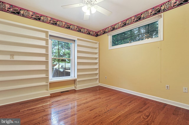 spare room featuring hardwood / wood-style floors and ceiling fan