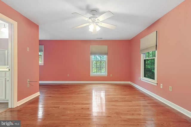 spare room featuring ceiling fan and light hardwood / wood-style floors