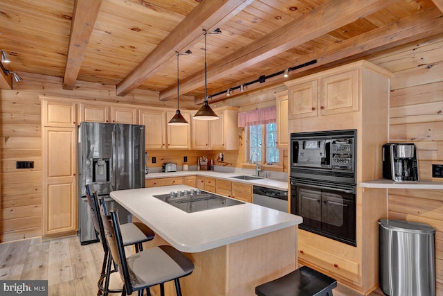 kitchen featuring wooden walls, light brown cabinetry, sink, wood ceiling, and black appliances