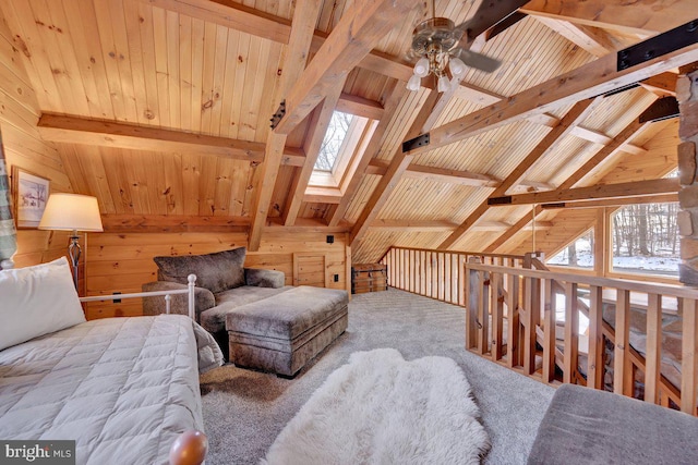 living area with a healthy amount of sunlight, wooden ceiling, and wooden walls