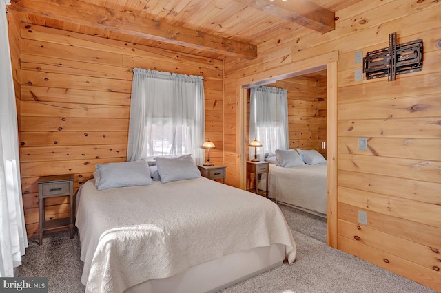 bedroom featuring wood ceiling, wooden walls, beamed ceiling, and carpet