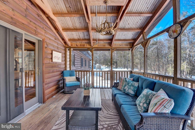 unfurnished sunroom with an inviting chandelier, vaulted ceiling with beams, and wooden ceiling