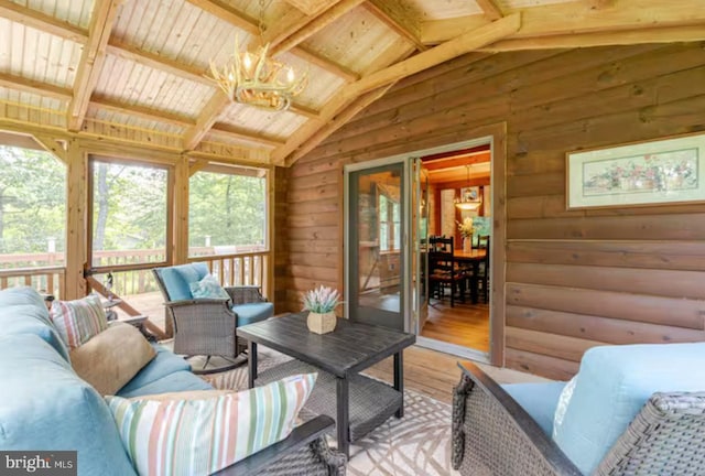 living room featuring vaulted ceiling with beams, wood walls, wood ceiling, wood-type flooring, and a notable chandelier