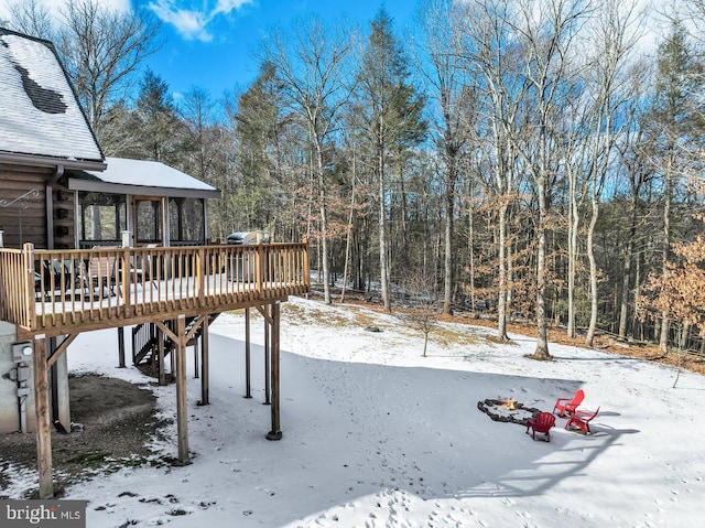 yard covered in snow with a wooden deck