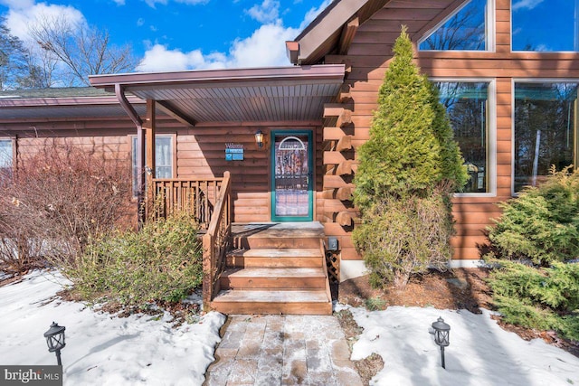 view of snow covered property entrance