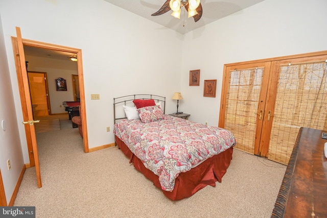 carpeted bedroom featuring access to exterior, vaulted ceiling, french doors, and ceiling fan