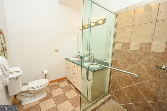 bathroom with an enclosed shower, vanity, tile patterned floors, and toilet