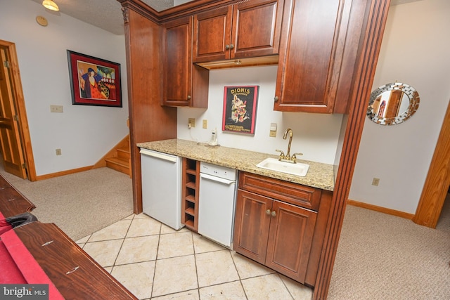 kitchen featuring light carpet, sink, light stone counters, and dishwasher