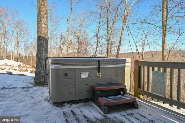 snow covered deck featuring a hot tub