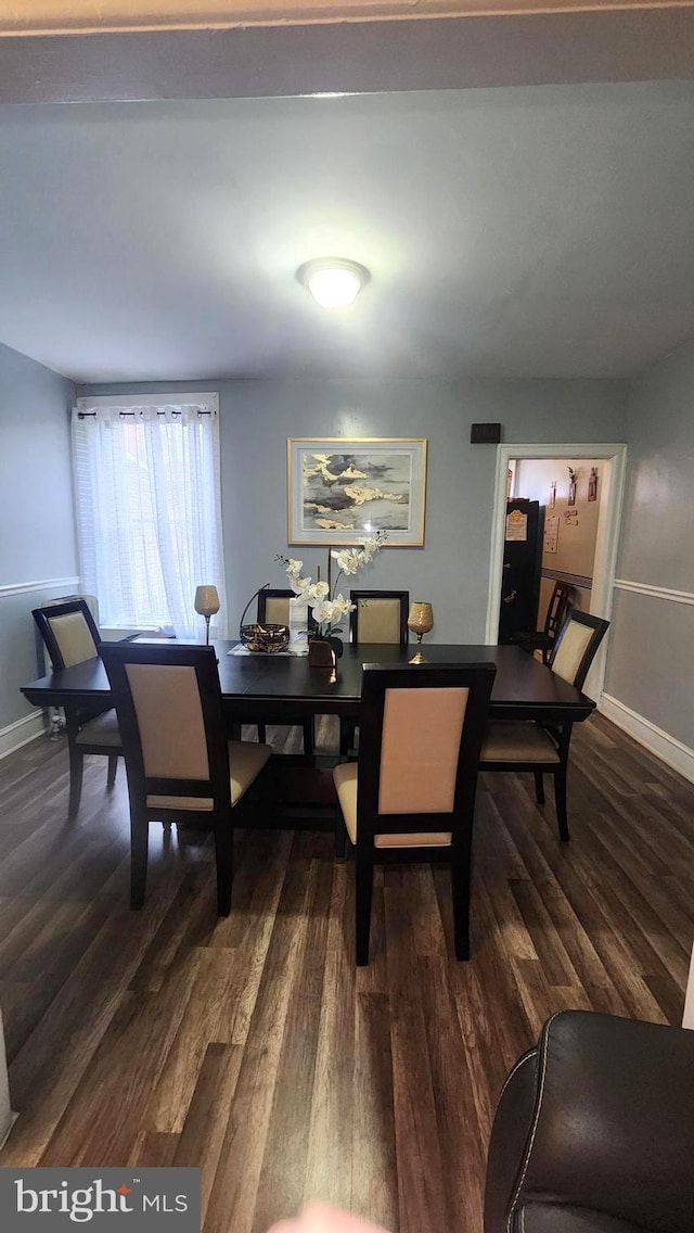 dining space with dark hardwood / wood-style floors