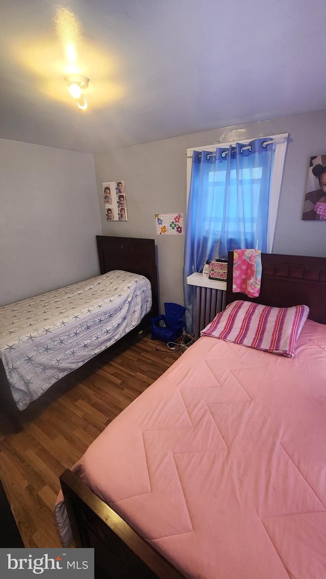 bedroom with hardwood / wood-style flooring