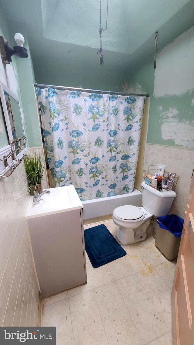 full bathroom featuring tile walls, vanity, shower / bath combination with curtain, and toilet