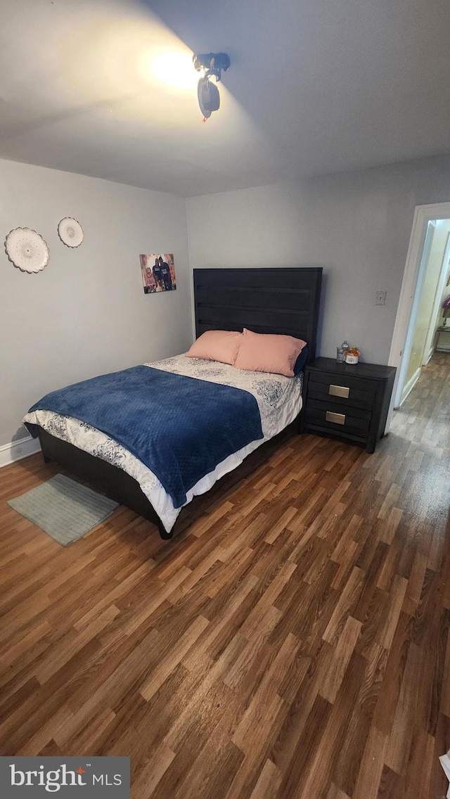 bedroom featuring dark wood-type flooring