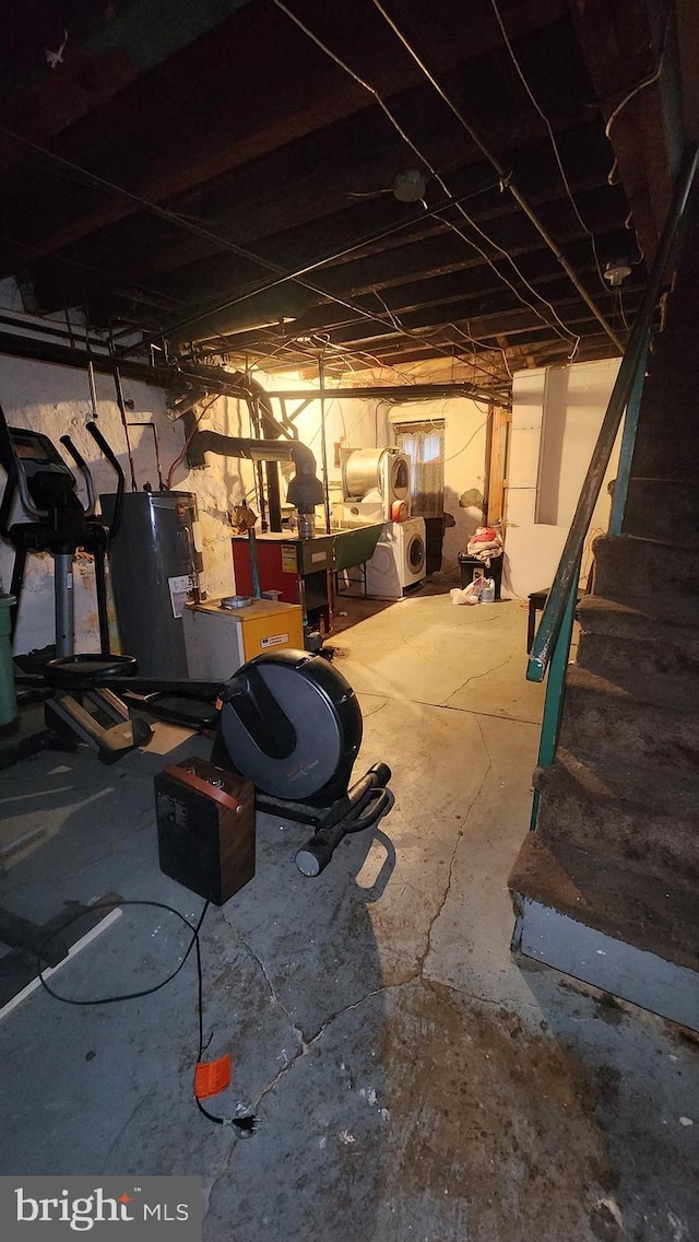 basement featuring electric water heater and washer and dryer