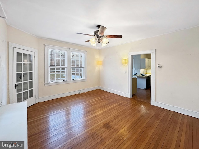 unfurnished room with hardwood / wood-style floors and ceiling fan