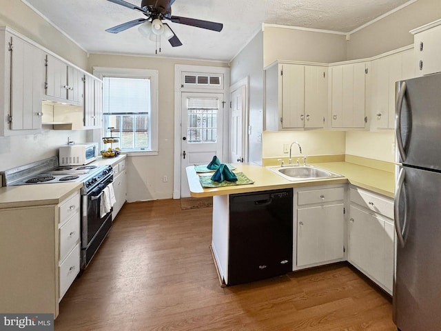 kitchen with sink, white cabinetry, range with electric stovetop, stainless steel fridge, and black dishwasher