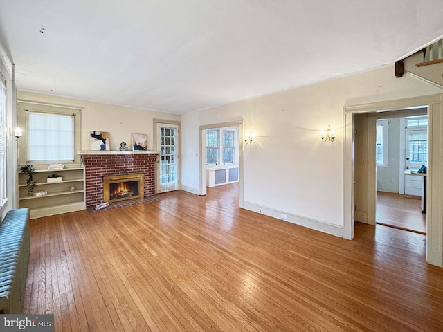 unfurnished living room featuring a fireplace and hardwood / wood-style floors