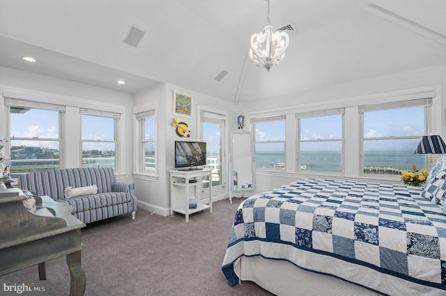 carpeted bedroom featuring lofted ceiling and a chandelier