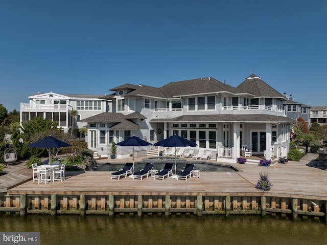 back of house featuring a deck with water view