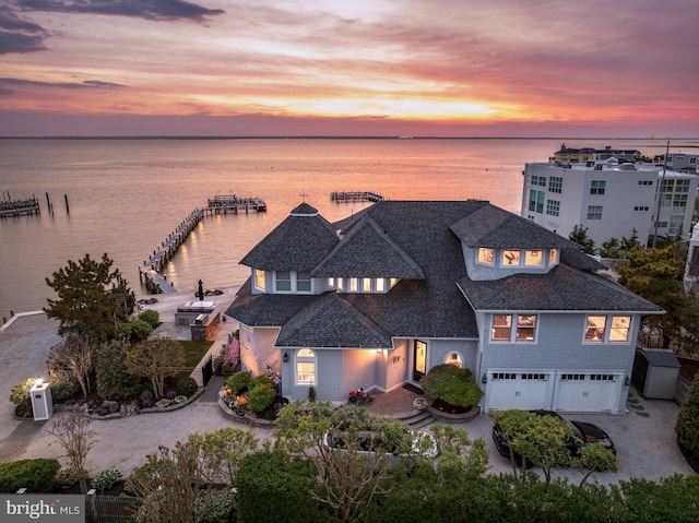 aerial view at dusk with a water view