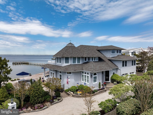 view of front of house with a water view