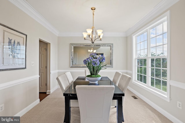 carpeted dining room with ornamental molding and a notable chandelier