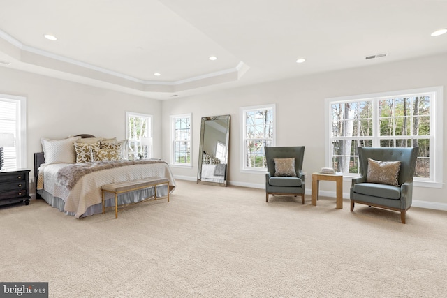 bedroom featuring crown molding, light colored carpet, and a raised ceiling