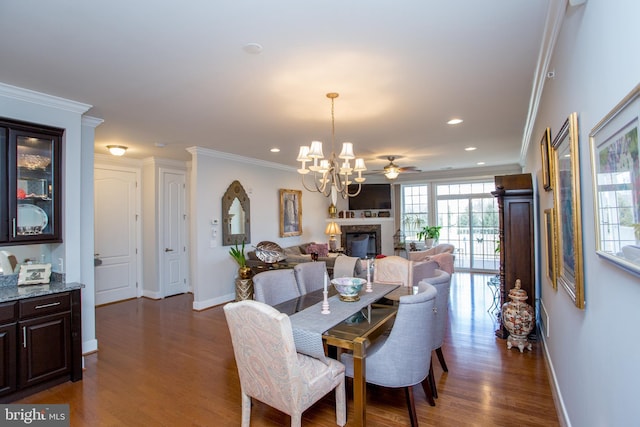 dining space featuring an inviting chandelier, crown molding, and dark wood-type flooring