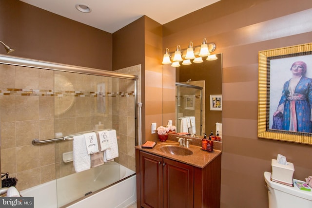 full bathroom with vanity, shower / bath combination with glass door, and toilet