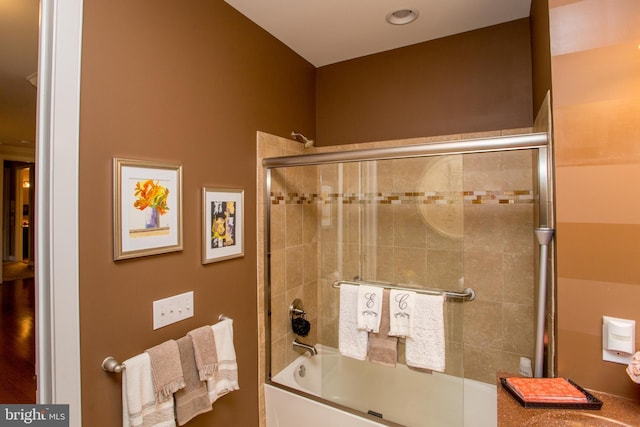 bathroom featuring shower / bath combination with glass door