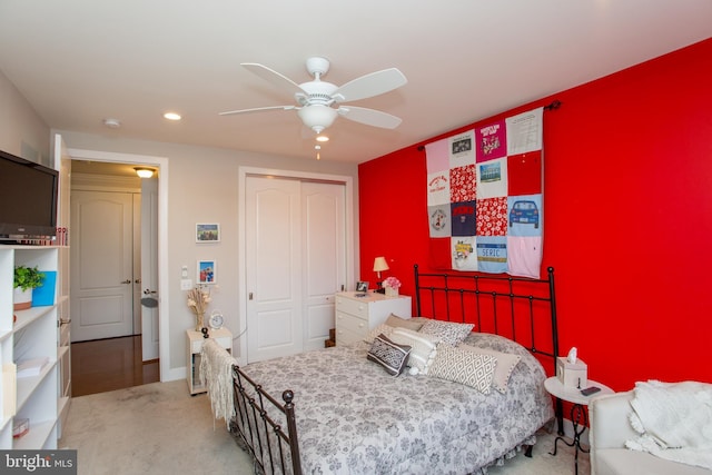 bedroom with light carpet, a closet, and ceiling fan